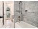Bathroom featuring a marble tiled shower, soaking tub, and stylish fixtures at 50 Howell Se St # A, Atlanta, GA 30312