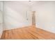 This empty bedroom features hardwood floors, neutral walls and an open doorway to another room at 50 Howell Se St # A, Atlanta, GA 30312