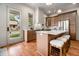 Bright kitchen featuring an island with seating, stainless steel appliances, and hardwood floors at 50 Howell Se St # A, Atlanta, GA 30312