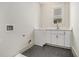 Functional laundry room with sleek herringbone floors, white cabinets, and convenient sink and countertop space at 50 Howell Se St # A, Atlanta, GA 30312