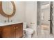 Charming powder room with a marble countertop vanity, decorative mirror, and mosaic tile floor at 50 Howell Se St # A, Atlanta, GA 30312