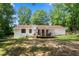 A vast backyard with a deck extending from the home, enclosed with a neat, white picket fence at 830 The Cir, Lawrenceville, GA 30043