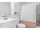 Bathroom featuring a modern sink, toilet, and shower at 830 The Cir, Lawrenceville, GA 30043