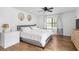 Bedroom featuring a large window, closet, and wood floors at 830 The Cir, Lawrenceville, GA 30043