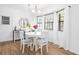 Bright dining area featuring a round table, four chairs, and large windows with sheer white curtains at 830 The Cir, Lawrenceville, GA 30043