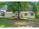 Quaint single-story house featuring a charming front porch and a lush green lawn at 830 The Cir, Lawrenceville, GA 30043