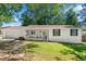 Charming single-story home with a covered porch and well-maintained lawn at 830 The Cir, Lawrenceville, GA 30043