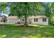 Quaint single-story house featuring a charming front porch and a lush green lawn at 830 The Cir, Lawrenceville, GA 30043