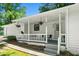 Inviting front porch with seating and hanging plants at 830 The Cir, Lawrenceville, GA 30043