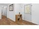 Bright hallway with wood floors, a storage shelf, and an entrance door at 830 The Cir, Lawrenceville, GA 30043