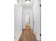 Hallway with wood floors and open doorways to rooms at 830 The Cir, Lawrenceville, GA 30043