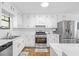 Well-lit kitchen featuring modern appliances, white cabinetry, and efficient layout for cooking and storage at 830 The Cir, Lawrenceville, GA 30043