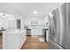 Bright and airy kitchen showcasing stainless steel appliances, white cabinetry, and a functional design at 830 The Cir, Lawrenceville, GA 30043