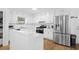 Modern kitchen featuring white cabinets, stainless steel appliances, and a functional kitchen island at 830 The Cir, Lawrenceville, GA 30043