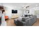 Bright living room featuring a large sectional sofa, modern entertainment center, and a cozy fireplace at 830 The Cir, Lawrenceville, GA 30043