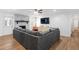 Cozy living room with a stone fireplace, large sofa, and hardwood flooring at 830 The Cir, Lawrenceville, GA 30043