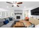 Inviting living room features a stone fireplace, ceiling fan, and ample natural light at 830 The Cir, Lawrenceville, GA 30043