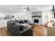 Open concept living room with a stone fireplace and view of the kitchen and dining area at 830 The Cir, Lawrenceville, GA 30043