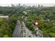Aerial view of property with city skyline in distance, surrounded by lush trees at 9 Saint Claire Ne Ln, Atlanta, GA 30324