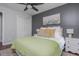 Stylish bedroom with an accent wall, ceiling fan, and hardwood floors at 9 Saint Claire Ne Ln, Atlanta, GA 30324