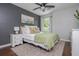 Cozy bedroom with a ceiling fan, dark accent wall, and hardwood floors at 9 Saint Claire Ne Ln, Atlanta, GA 30324