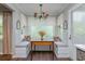 Sunlit breakfast nook with large window, built-in seating and decorative lighting fixture at 9 Saint Claire Ne Ln, Atlanta, GA 30324