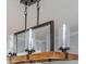 Modern chandelier with wood and glass accents adds a touch of elegance to any dining or living space at 9 Saint Claire Ne Ln, Atlanta, GA 30324
