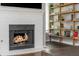 Close-up of a fireplace with a white brick surround and a built-in bookcase to the right at 9 Saint Claire Ne Ln, Atlanta, GA 30324