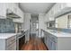 Modern kitchen design featuring stainless steel appliances, white countertops, and wood flooring at 9 Saint Claire Ne Ln, Atlanta, GA 30324