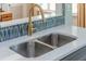 Kitchen sink with stainless steel basin and contemporary faucet, showcasing the backsplash at 9 Saint Claire Ne Ln, Atlanta, GA 30324