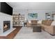 Cozy living room features a fireplace, large sectional sofa, hardwood floors, and stylish decor at 9 Saint Claire Ne Ln, Atlanta, GA 30324