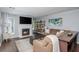 Comfortable living area with a fireplace, large TV, hardwood floors, and stylish furnishings at 9 Saint Claire Ne Ln, Atlanta, GA 30324