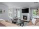 Well-lit living space with fireplace, TV, hardwood flooring, and comfortable seating at 9 Saint Claire Ne Ln, Atlanta, GA 30324