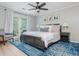 Cozy main bedroom with a blue rug, a ceiling fan, and access to a private balcony at 9 Saint Claire Ne Ln, Atlanta, GA 30324
