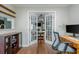 Open office showcasing hardwood floors, modern decor, and seamless connectivity to the dining area at 9 Saint Claire Ne Ln, Atlanta, GA 30324