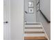 Staircase featuring carpeted steps, a dark metal handrail, and neutral-toned walls at 9 Saint Claire Ne Ln, Atlanta, GA 30324