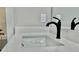 Close-up of a modern bathroom sink featuring a matte black faucet and white quartz countertops at 12 Confederate Nw St, Cartersville, GA 30121