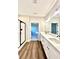 Modern bathroom with dual sinks, quartz countertop, a glass shower, and wood-look floors at 12 Confederate Nw St, Cartersville, GA 30121