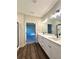 Elegant bathroom with dual sinks, quartz countertop, and modern lighting fixtures with wood-look floors at 12 Confederate Nw St, Cartersville, GA 30121