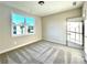 Well-lit bedroom featuring large window, soft carpet, neutral paint, and a paneled door at 12 Confederate Nw St, Cartersville, GA 30121