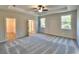 Spacious main bedroom with tray ceiling, large windows, and an open doorway to the en-suite bathroom at 12 Confederate Nw St, Cartersville, GA 30121