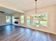 Bright dining room featuring hardwood floors, a modern chandelier, and a view of the landscaped backyard at 12 Confederate Nw St, Cartersville, GA 30121