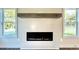 Modern fireplace with floating mantel and white shiplap surround flanked by large windows at 12 Confederate Nw St, Cartersville, GA 30121
