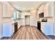 Modern kitchen featuring white cabinets, hardwood floors, and updated appliances at 12 Confederate Nw St, Cartersville, GA 30121