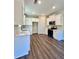 Stylish kitchen with stainless steel appliances, white cabinets, and hardwood floors at 12 Confederate Nw St, Cartersville, GA 30121