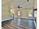 Open living room with hardwood floors, ceiling fan, and staircase leading to the upper level at 12 Confederate Nw St, Cartersville, GA 30121