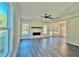 Bright living room with modern fireplace, ceiling fan, and abundant natural light from large windows at 12 Confederate Nw St, Cartersville, GA 30121