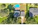 Aerial view of a property with a pool, expansive lawn, mature trees, and proximity to neighborhood amenities at 1406 Arden Sw Dr, Marietta, GA 30008