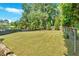 Expansive, well-maintained backyard with lush lawn and mature trees provides ample space for outdoor activities at 1406 Arden Sw Dr, Marietta, GA 30008