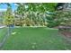 Expansive backyard with lush green grass and a chain link fence offers plenty of room to roam at 1406 Arden Sw Dr, Marietta, GA 30008
